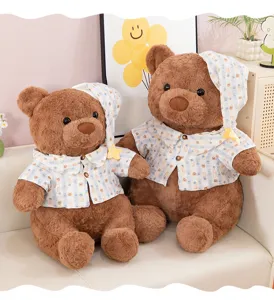 Cute brown plush teddy bear doll in plaid shirt and nightcap, soft toy for birthday gifts.
