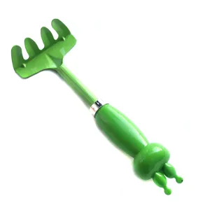 Detail view of the green kids gardening rake, showing the cute cartoon handle design.