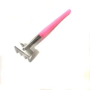Mini garden rake with pink plastic handle and metal tines for succulent potted plants.