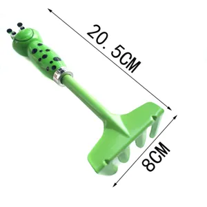 Children cartoon frog garden rake detail view, green beach sand digging tool size display.
