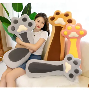 Cute cat paw plush pillow detail shot, cozy bedroom scene with soft stuffed toy companion.