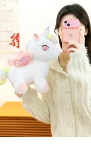 Vista dettagliata del simpatico peluche unicorno arcobeno con ali morbide e criniera.