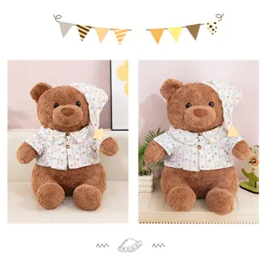 Detailed view of the cute brown teddy bear plush toy wearing a lovely pajama shirt and nightcap.