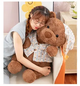 Cute brown teddy bear plush toy wearing a cute shirt and nightcap, soft hugging doll for gift.