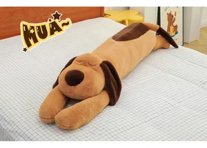 Long lying dog plush toy detail showing soft brown and beige fur, cute sleeping expression on bed.