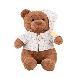 Cute brown teddy bear plush toy wearing adorable pajamas and nightcap, soft stuffed gift.