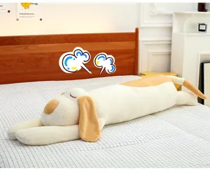 Long plush dog pillow, soft cartoon animal body pillow for sleeping on bed in bedroom.