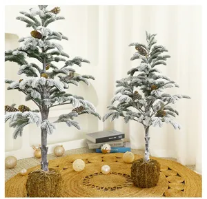 Detailed view of artificial flocked Christmas trees with moss ball bases and pine cones