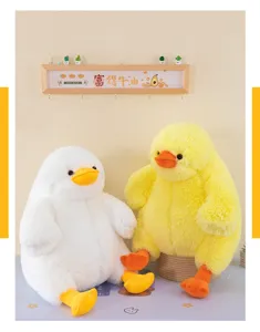 Fluffy fat duck plush toy detail view, soft cute yellow and white stuffed pillow doll display.