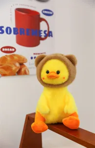 Cute plush yellow duck toy with brown bear hat, soft stuffed animal doll gift detail.