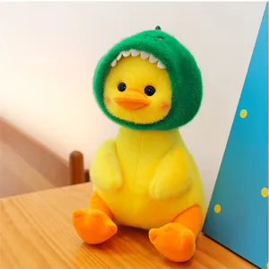 Cute yellow duck plush toy wearing green dinosaur hood, soft doll detail display.