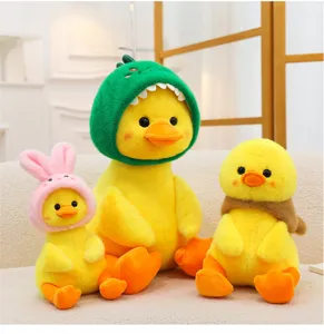 Close-up detail of cute yellow duck plush toys wearing funny dinosaur and bunny hats.