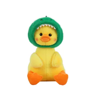 Cute yellow plush duck toy wearing green dinosaur hat, soft stuffed animal doll for gifts.