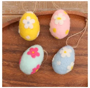 Detailed view of handmade colorful wool felt Easter eggs with floral patterns