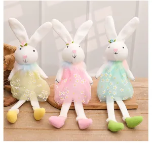 Close-up detail of three cute Easter rabbit plush dolls wearing colorful floral dresses