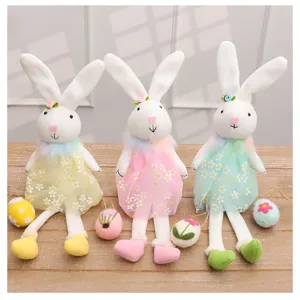 Three adorable Easter bunny plush dolls in pastel daisy dresses, perfect for holiday decor.
