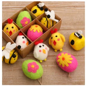 Detailed view of colorful felt Easter egg, chick, and bee ornaments in a cardboard box