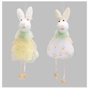Detailed macro view of two Easter bunny hanging ornaments with floral dresses