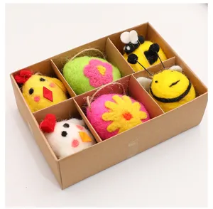 Detailed close-up of a handmade Easter wool felt ornament set in a craft gift box.