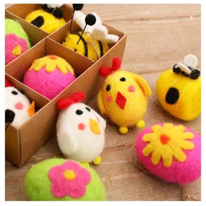 Detailed view of handmade needle felt Easter ornaments including bees and chicks