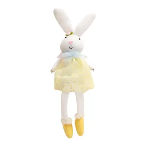 Adorable Easter bunny plush doll wearing a yellow daisy floral dress and small boots