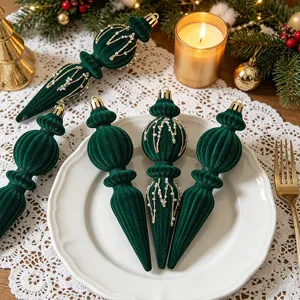 Close-up of dark green velvet finial Christmas ornaments with intricate gold beaded accents