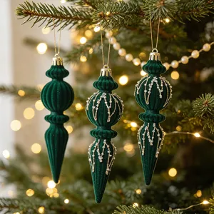 Macro view of elegant green velvet Christmas finial ornaments with gold and pearl details