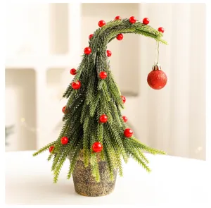 Unique mini Christmas tree with bent top design and festive red glitter ball ornament