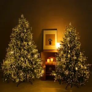 Pre-lit artificial Christmas tree with crystal snowflake ornaments and warm LED lights
