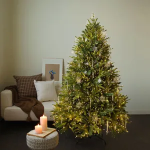 Large artificial Christmas tree with crystal snowflake ornaments and warm LED lights