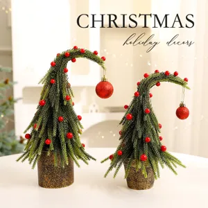 Bent mini Christmas tree tabletop decorations with festive red berries and ball ornaments
