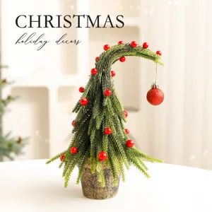 Decorative mini Christmas tree with curved top and red berries in a stylish pot