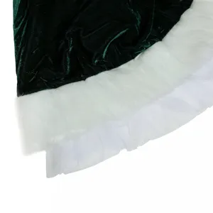 Detailed shot of Christmas costume hem featuring green velvet, white faux fur, and mesh.