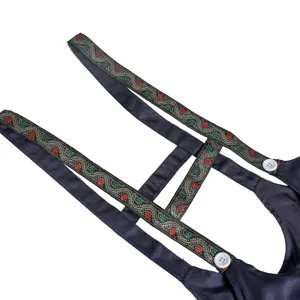 Close-up detail of Oktoberfest dress straps with traditional folk floral embroidery and buttons.