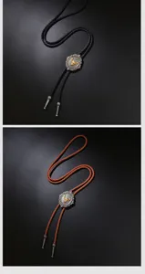 Detailed view of vintage western bolo ties featuring engraved bull head pendants.