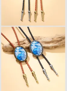 Detail of Western cowboy bolo tie featuring blue rabbit illustration on braided leather cord