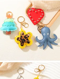 Close-up detail of variety PU leather keychains with octopus, heart and tree shapes
