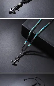 Detailed view of vintage anchor pendant necklace with natural lava and turquoise beads.