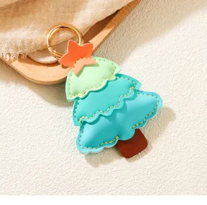 Close-up of a colorful Christmas tree PU leather keychain with gold ring for bags