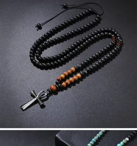 Close-up of matte black natural stone beads necklace with a metallic Ankh cross pendant.