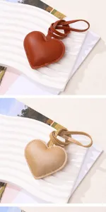 Detailed view of brown and tan PU leather heart-shaped bag charms with cord straps
