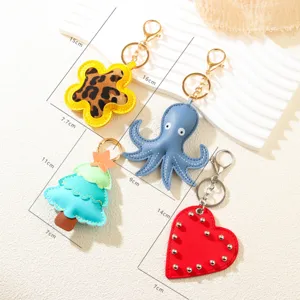 Creative PU leather keychains set featuring octopus heart and Christmas tree charms