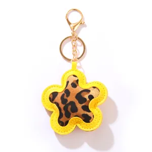 Stylish yellow PU leather star-shaped keychain featuring a trendy leopard print design