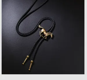 Detailed macro shot of a vintage bronze horse pendant on a braided black leather bolo tie cord
