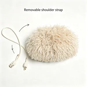 Close-up of beige faux fur cloud bag with a removable shoulder strap detail