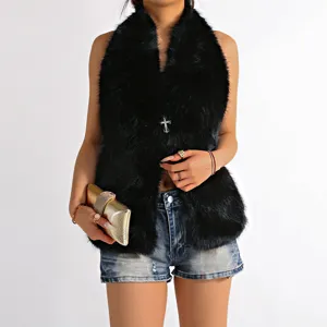 Professional detail shot of a black faux fur halter top featuring a crystal cross pendant.