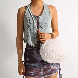 Detailed view of white faux fur ball bag with soft plush texture for stylish outfit
