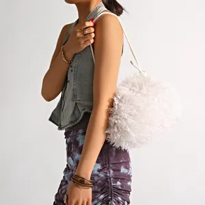 Chic faux fur cloud bag featuring soft plush texture and sleek white cord strap details