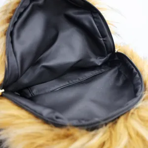 Detailed view of black inner lining and spacious pocket of faux raccoon fur backpack