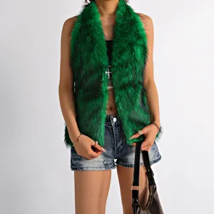 Detail of green faux fur halter top with cross pendant on model.